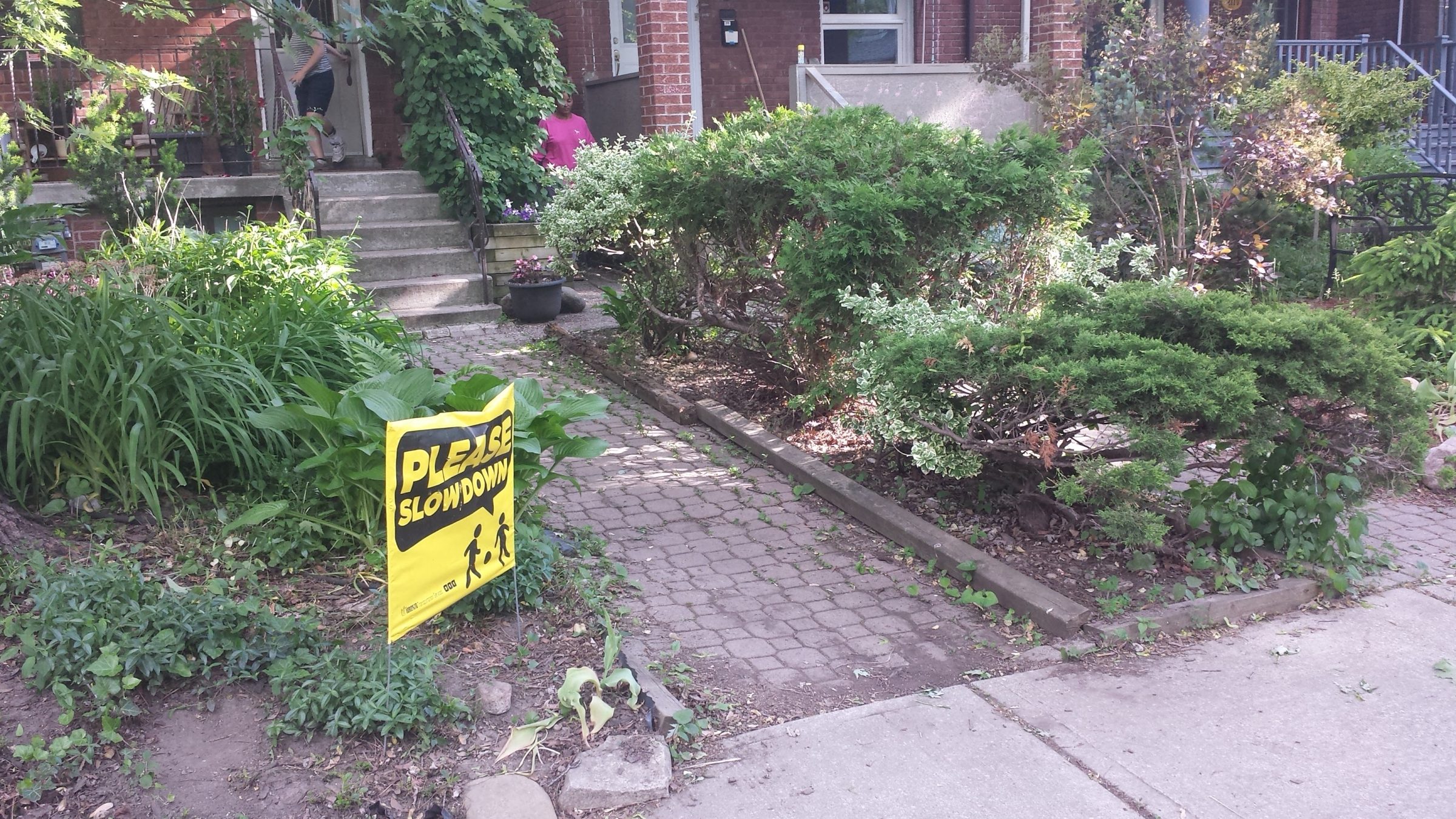 Front yard with 'Please Slow Down' sign.