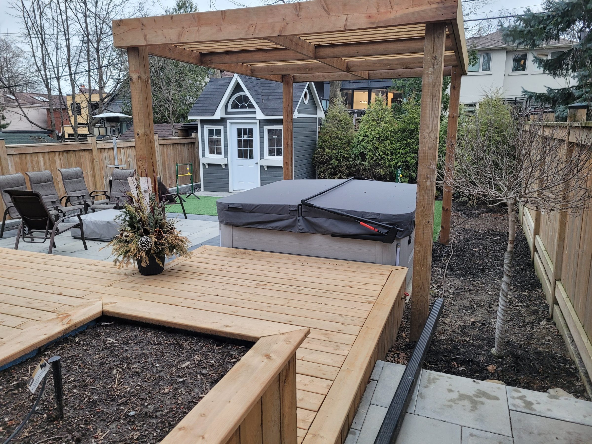 Backyard with gazebo, hot tub, and small playhouse.