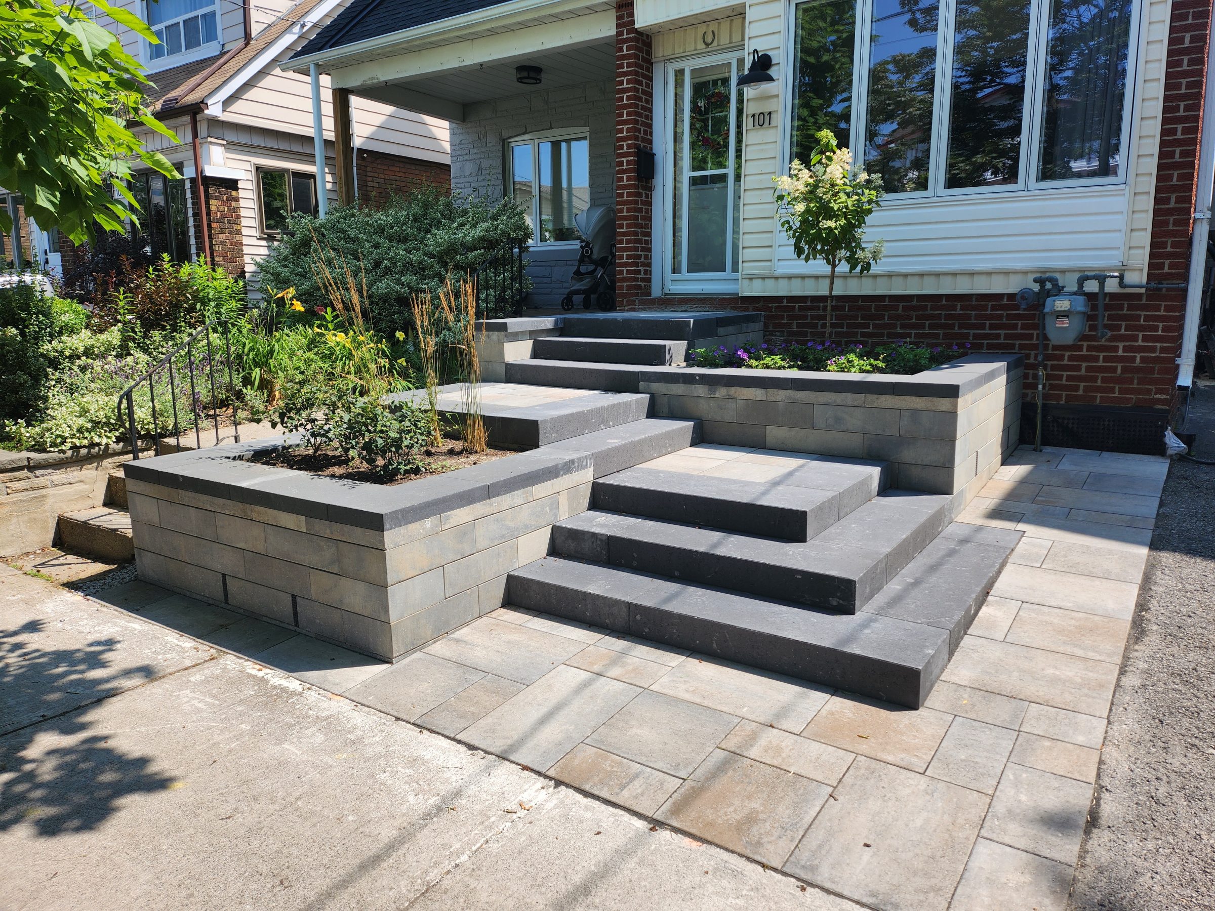 Modern front porch with garden steps and plants.