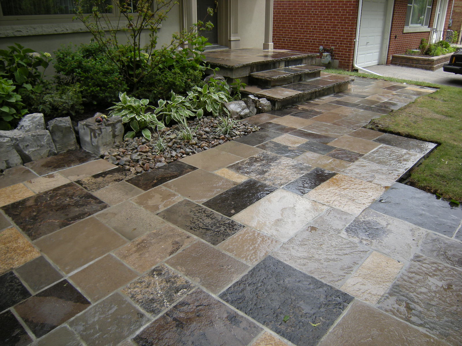 Wet tiled pathway with adjacent garden
